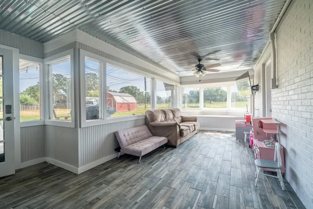 a living room with furniture and a floor to ceiling window