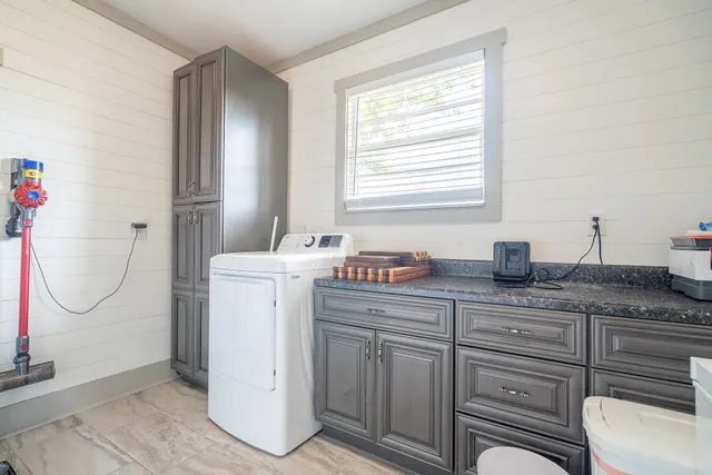 a spacious bathroom with a granite countertop sink and a mirror