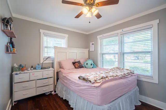 a bedroom with a bed and a window dresser