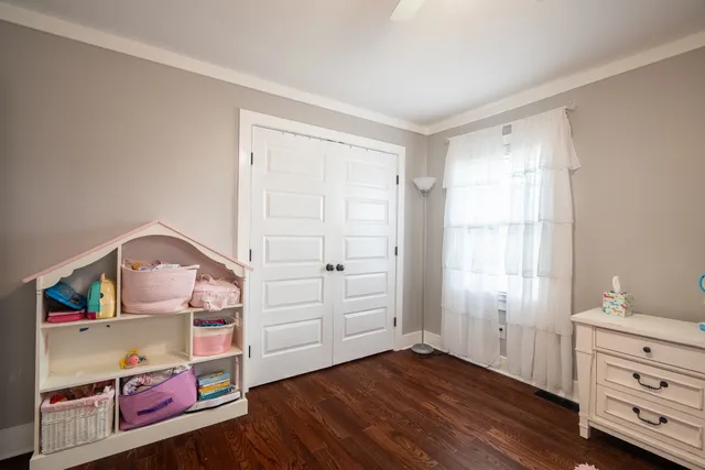 an entryway with a dresser and a window