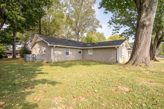 a view of a house with pool and tree s