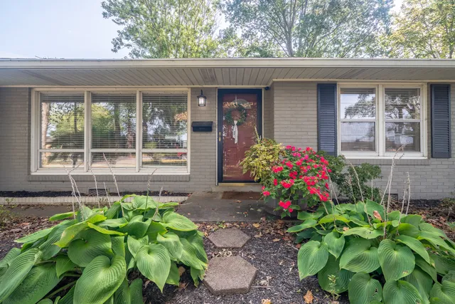 a flower garden in front of a house