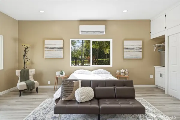 a bed room with a bed and wooden floor