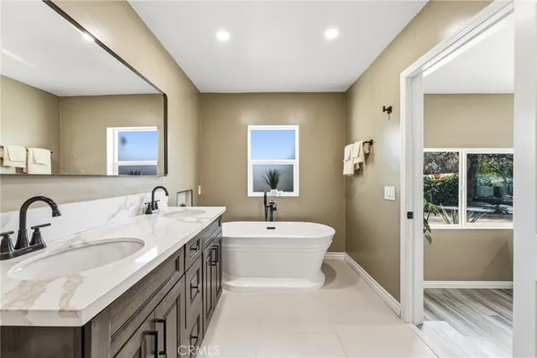 a bathroom with a granite countertop sink a toilet and shower