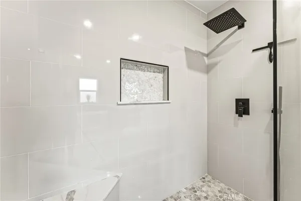 a bedroom with furniture and a flat screen tv