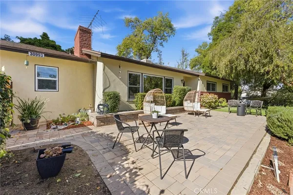 a view of a patio with a table chairs and a backyard