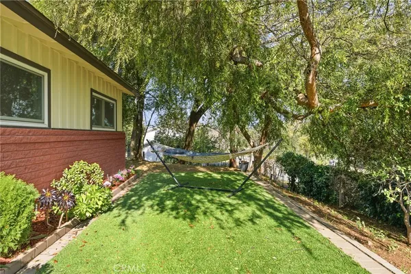 a view of a patio with dining table and chairs with plants