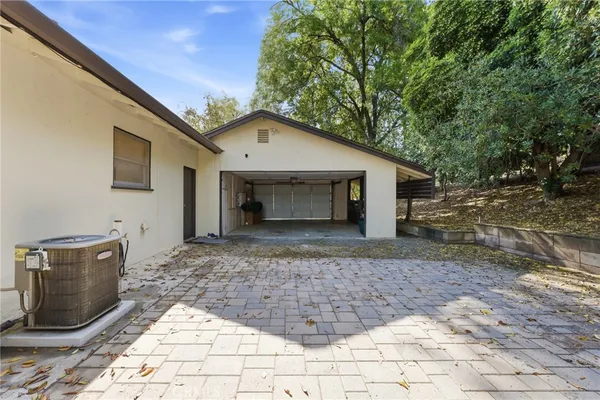 an aerial view of residential building with outdoor space and trees