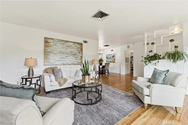 a view of a dining room with furniture wooden floor and chandelier