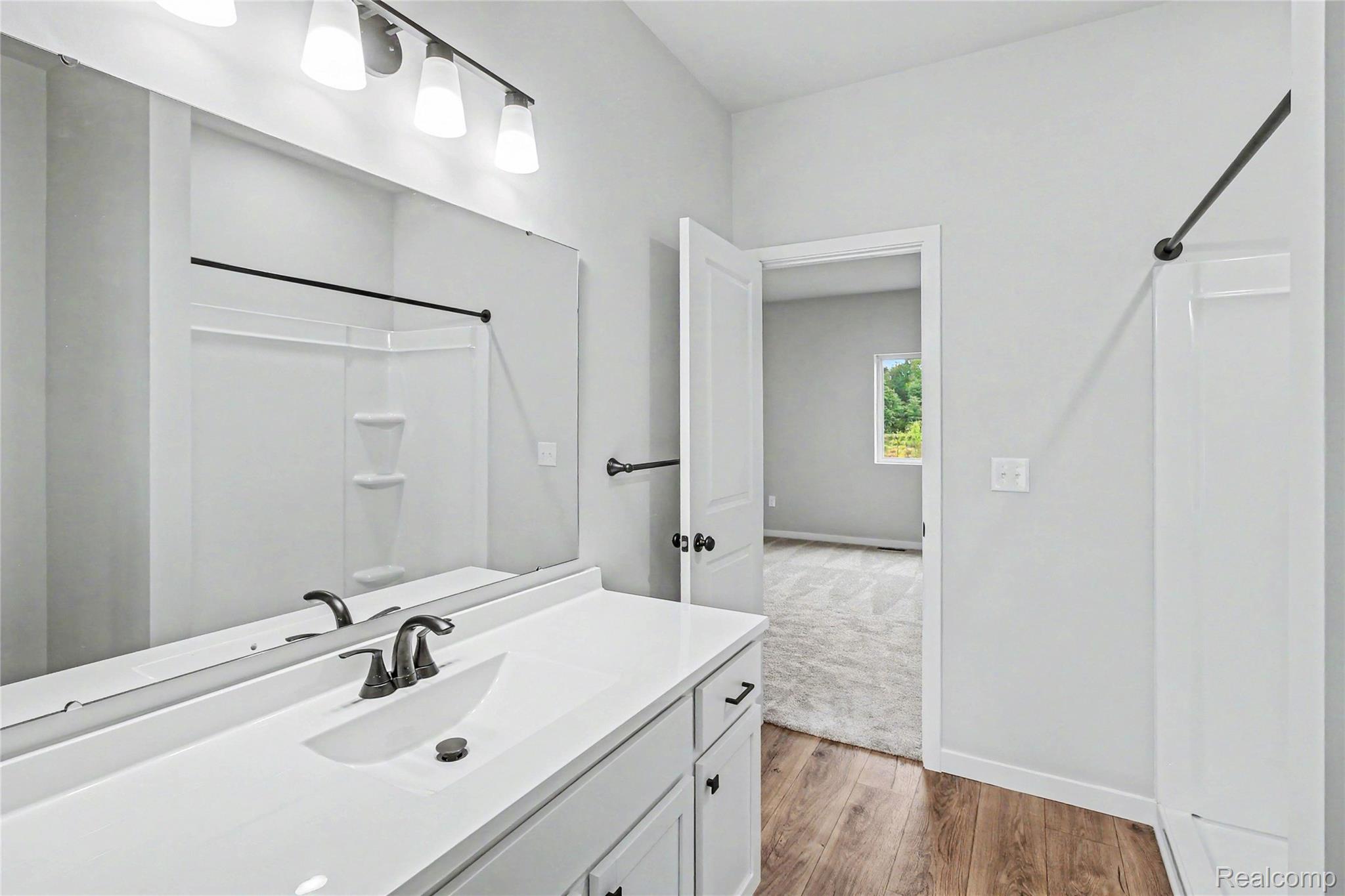1210 Lockes Street Howell, MI 48843 - Photo 12 of 37 The primary suite is located on the upper level and includes a private bath and oversized walk-in closet with large window for natural lighting.