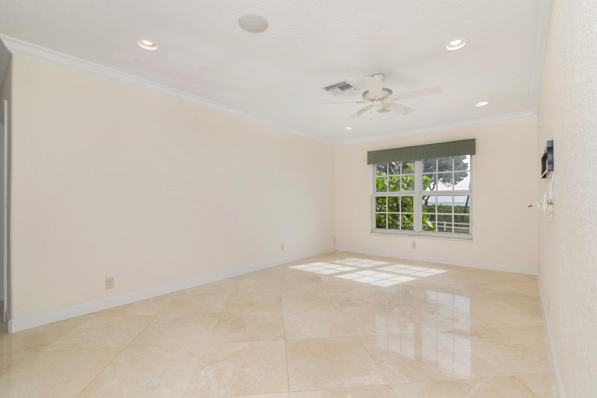 5505 North Ocean Boulevard, Unit 15204 Ocean Ridge, FL 33435 - Photo 13 of 34 an empty room with a window and a ceiling fan