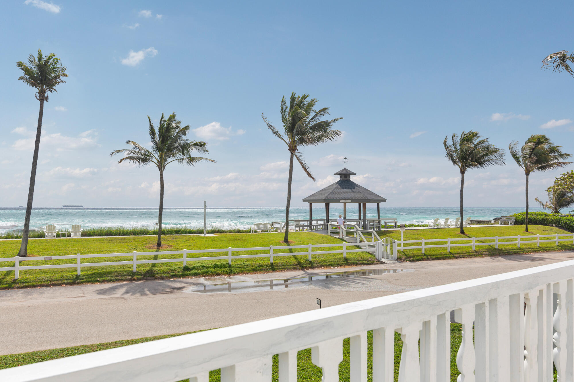 5505 North Ocean Boulevard, Unit 15204 Ocean Ridge, FL 33435 - Photo 26 of 34 a view of a swimming pool with a yard and palm trees