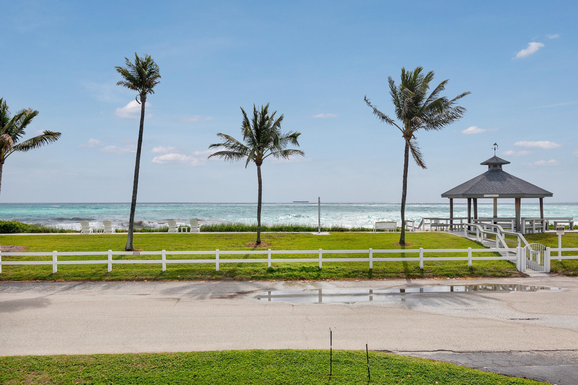 5505 North Ocean Boulevard, Unit 15204 Ocean Ridge, FL 33435 - Photo 27 of 34 a view of a swimming pool with a chair and palm trees