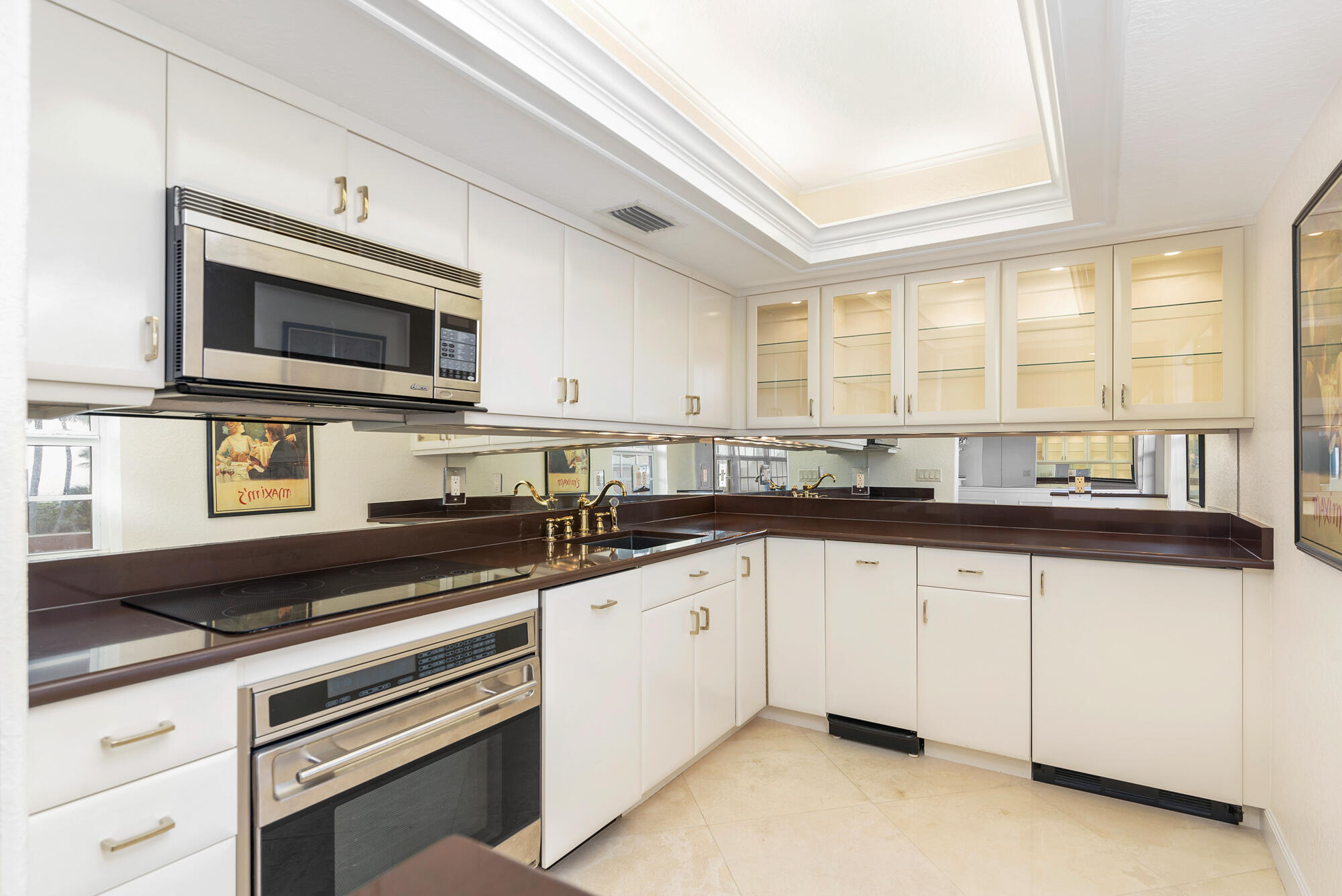 5505 North Ocean Boulevard, Unit 15204 Ocean Ridge, FL 33435 - Photo 10 of 34 a kitchen with granite countertop a sink stainless steel appliances and cabinets
