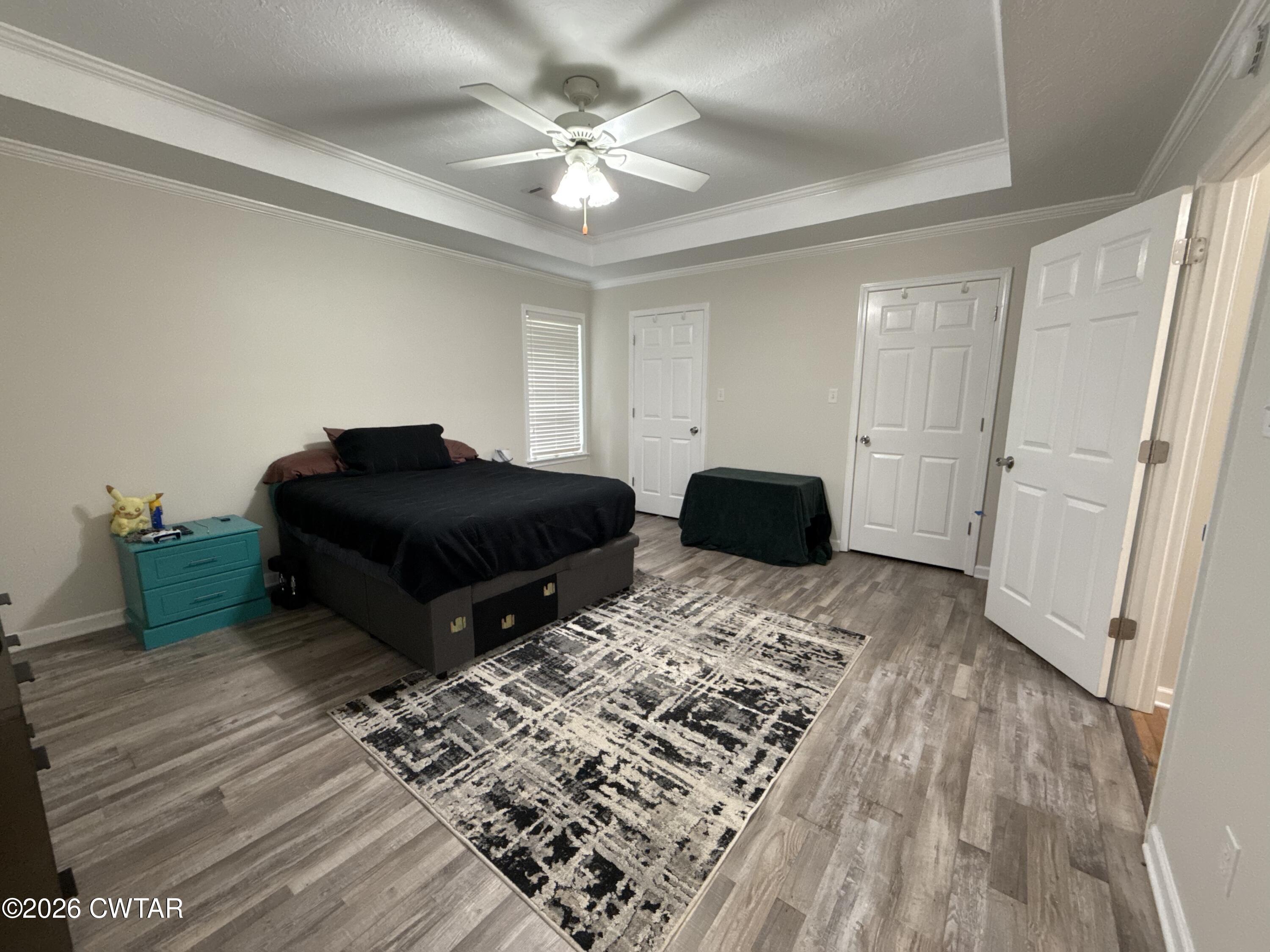 126 Waldunn Cove Rutherford, TN 38369 - Photo 8 of 18 a bedroom with a bed lamp and a dresser