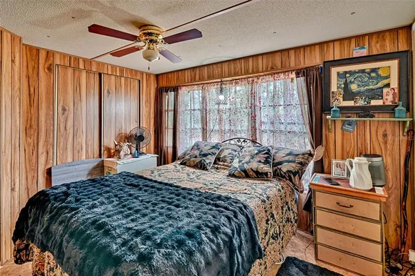 a bedroom with a bed and a large window