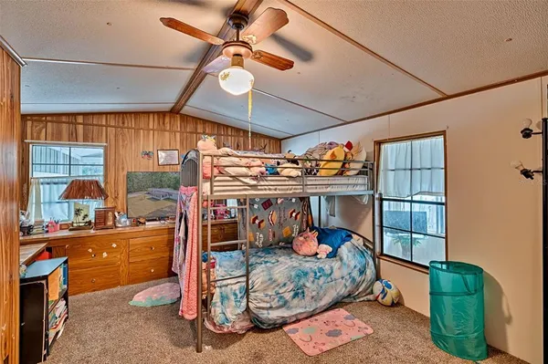 a bedroom with furniture next to a window