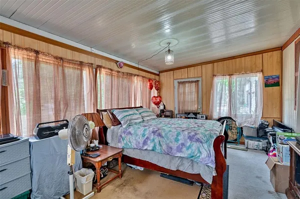 a bedroom with furniture and large windows