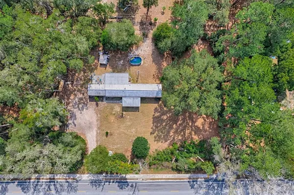 an aerial view of a house with outdoor space