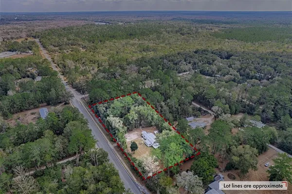 an aerial view of a house with a yard