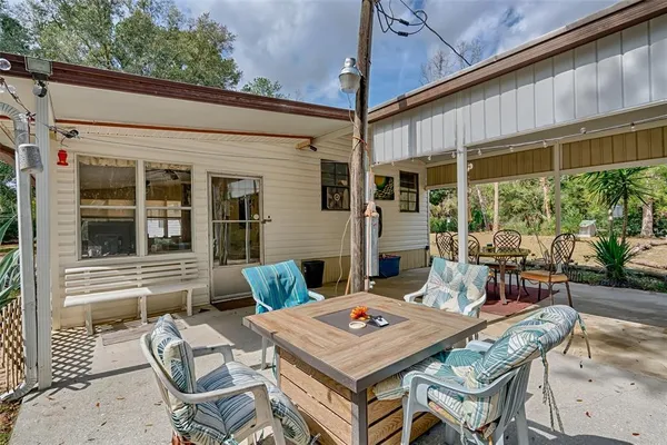 a patio with a table and chairs