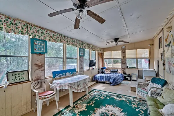 a living room with furniture and a floor to ceiling window