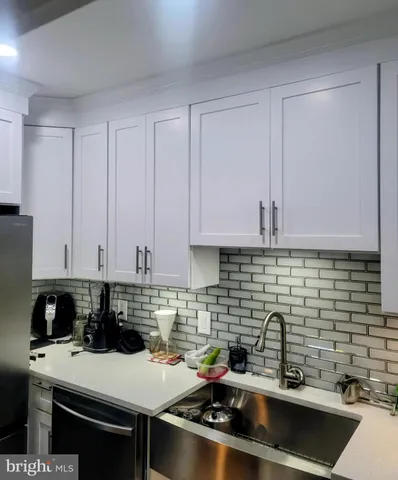 a kitchen with a sink and cabinets