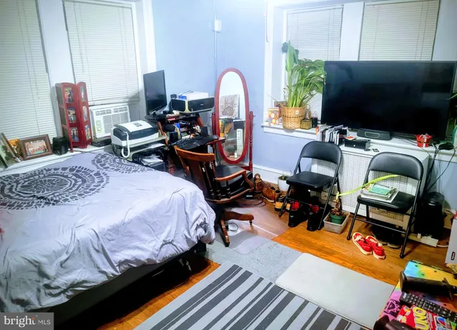 a bedroom with bed and a flat screen tv