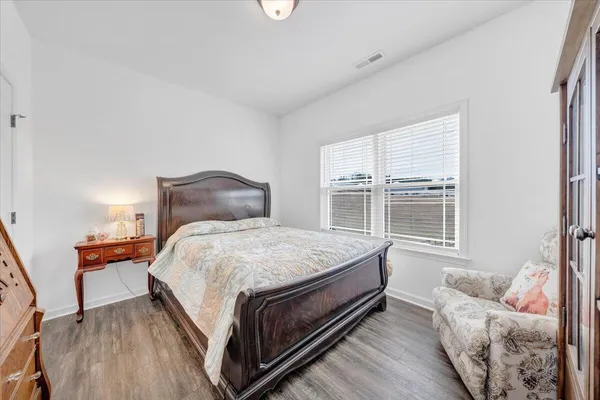 a bedroom with a bed and window