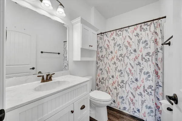 a bathroom with a sink toilet and shower