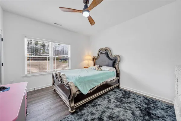 a bed sitting in a bedroom next to a window