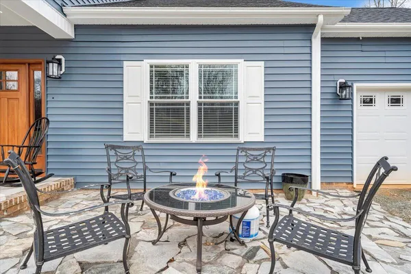 a view of a chairs and table in the balcony