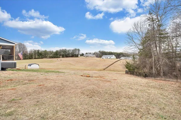 a view of yard with large trees and covered with green space