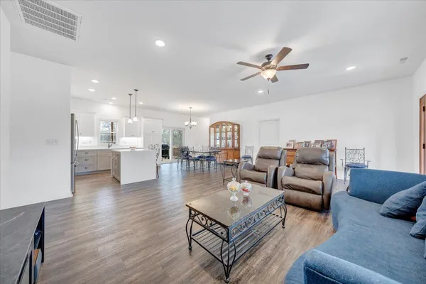 a living room with furniture or kitchen view and a wooden floor
