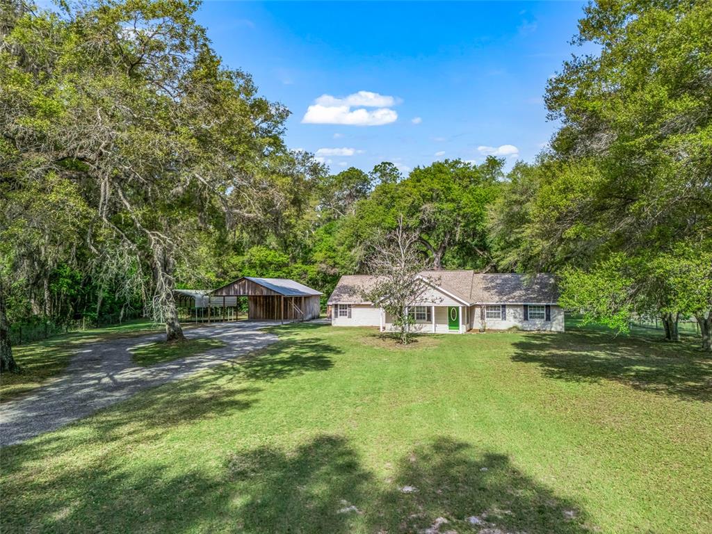 8234 Highway 301 Bushnell, FL 33513 - Photo 1 of 52 a view of a house with pool and a yard