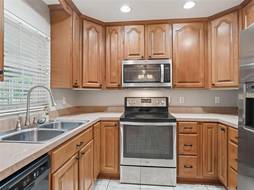 8234 Highway 301 Bushnell, FL 33513 - Photo 12 of 52 a kitchen with cabinets stainless steel appliances and a sink