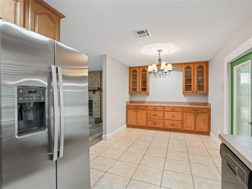 8234 Highway 301 Bushnell, FL 33513 - Photo 13 of 52 a kitchen with stainless steel appliances kitchen island granite countertop a refrigerator and a sink