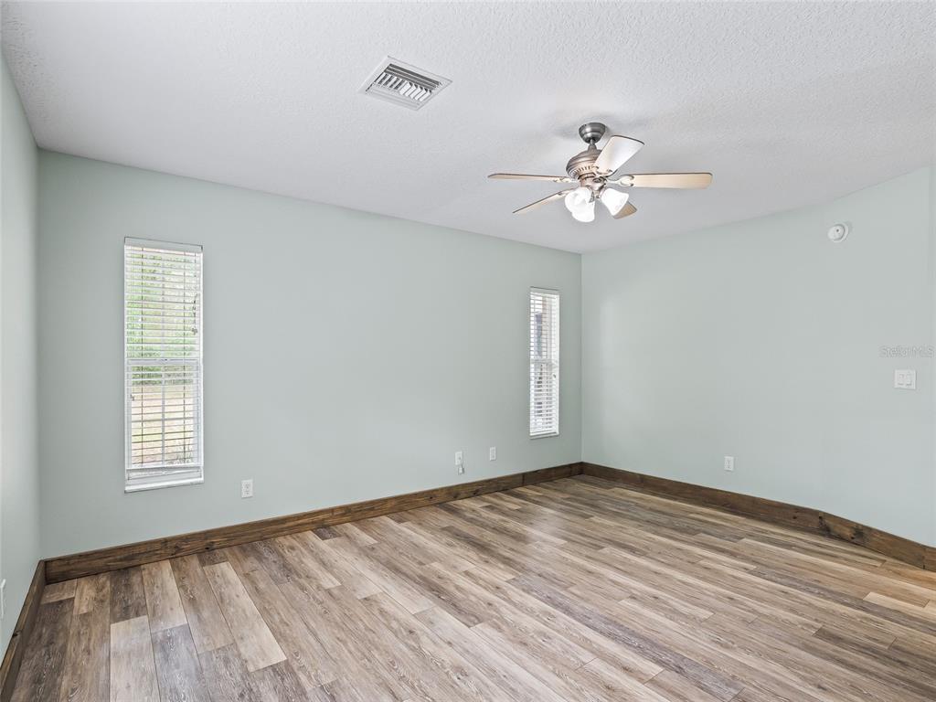 8234 Highway 301 Bushnell, FL 33513 - Photo 15 of 52 a view of empty room with wooden floor and fan