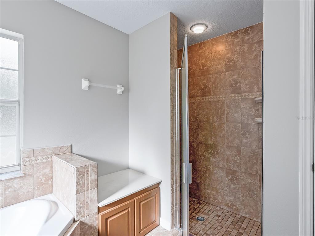 8234 Highway 301 Bushnell, FL 33513 - Photo 18 of 52 a bathroom with a granite countertop shower a sink and a toilet