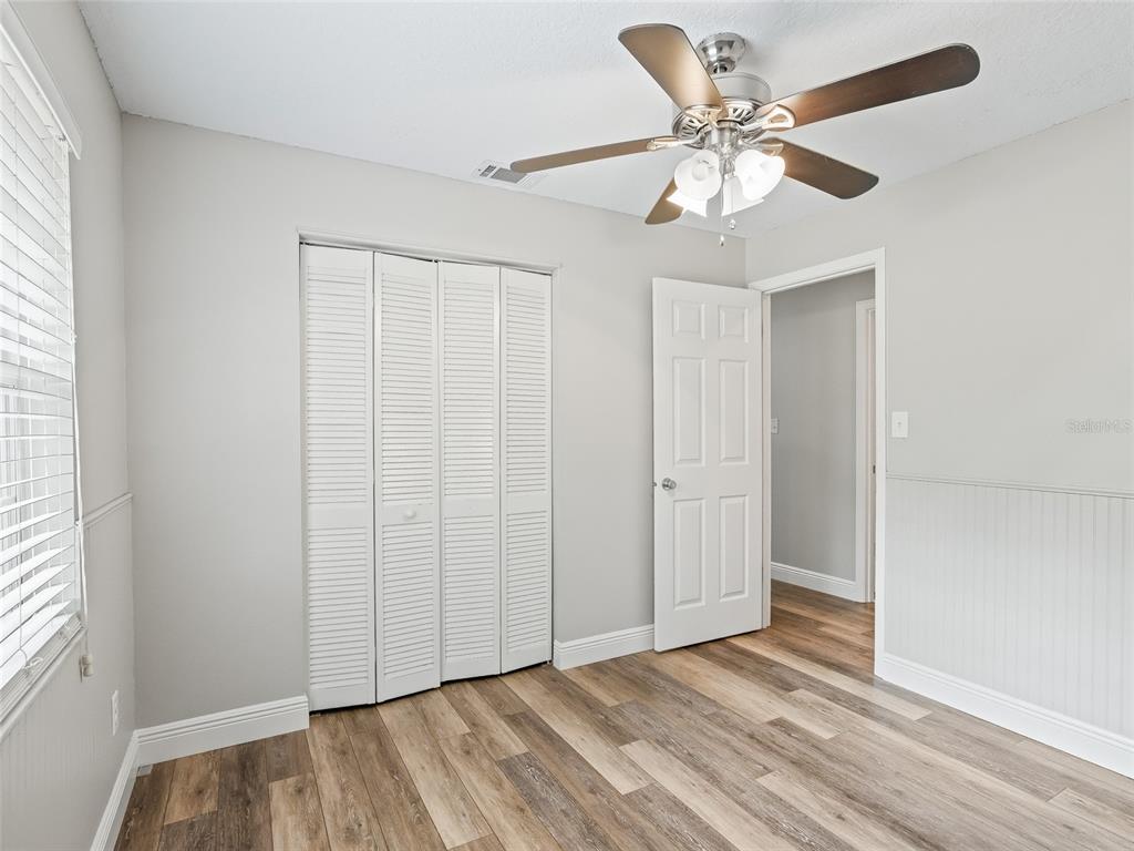 8234 Highway 301 Bushnell, FL 33513 - Photo 24 of 52 a view of an empty room with wooden floor