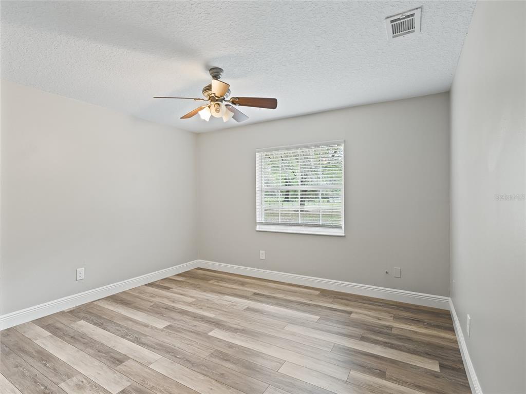 8234 Highway 301 Bushnell, FL 33513 - Photo 27 of 52 a view of a room with a ceiling fan and a window