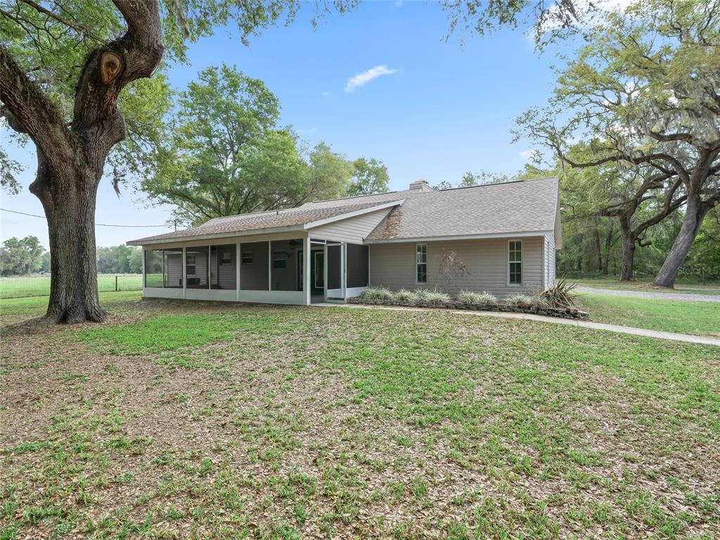 8234 Highway 301 Bushnell, FL 33513 - Photo 31 of 52 a house with huge green field in front of it