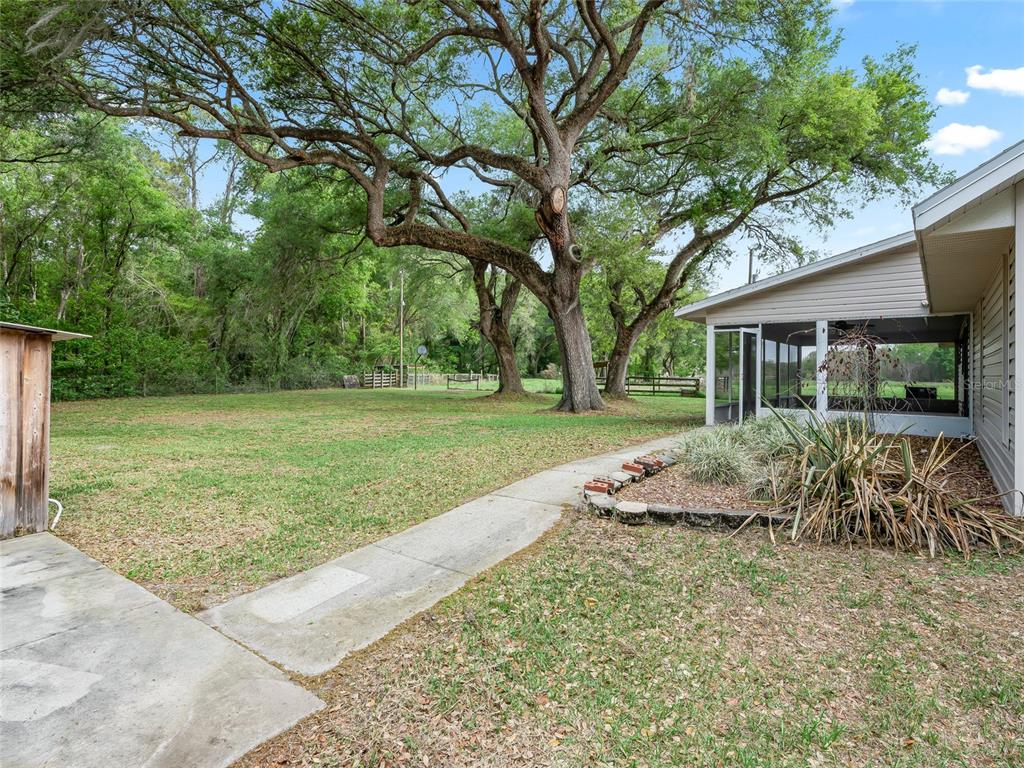 8234 Highway 301 Bushnell, FL 33513 - Photo 32 of 52 a view of a house with backyard and a garden