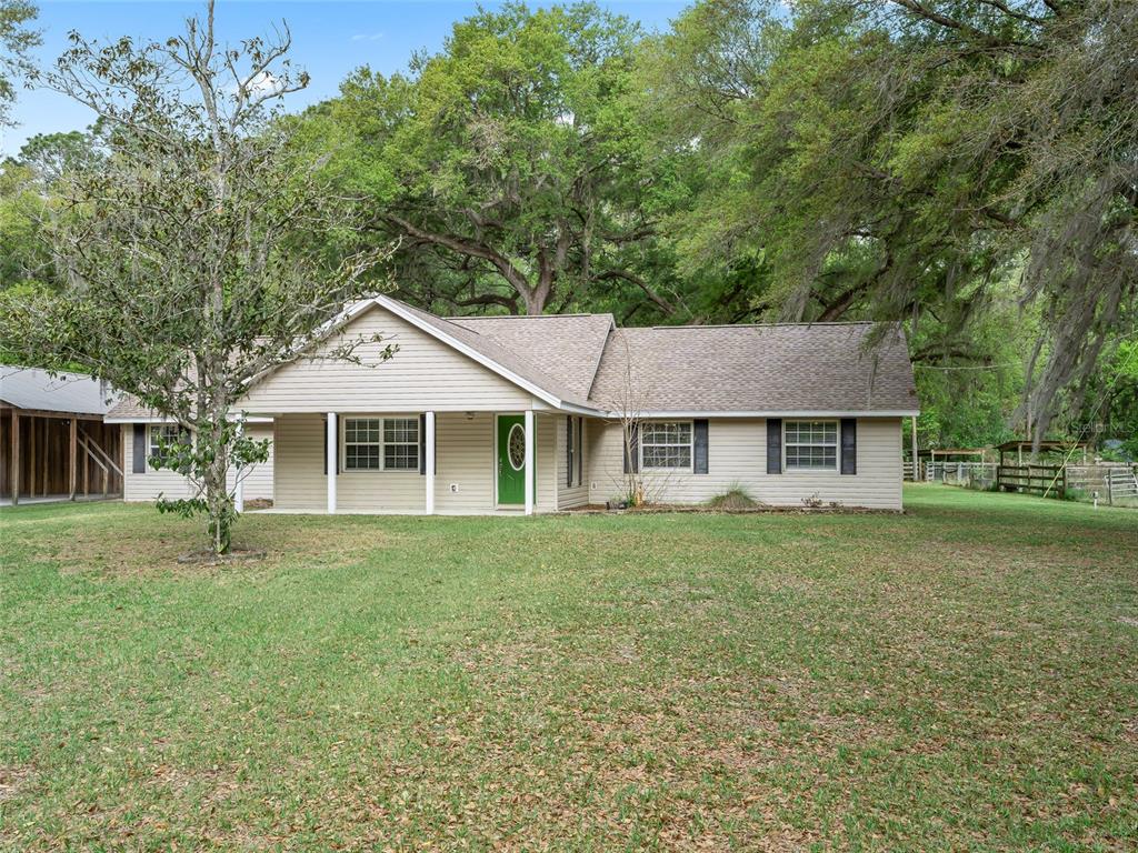 8234 Highway 301 Bushnell, FL 33513 - Photo 48 of 52 a front view of a house with a garden