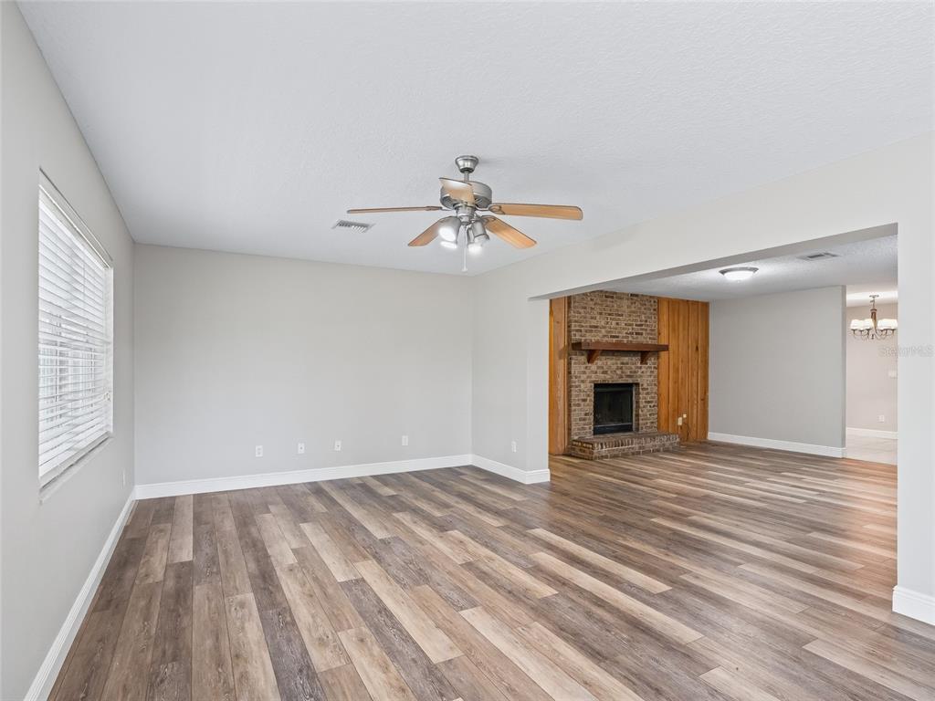 8234 Highway 301 Bushnell, FL 33513 - Photo 5 of 52 wooden floor in an empty room with a window