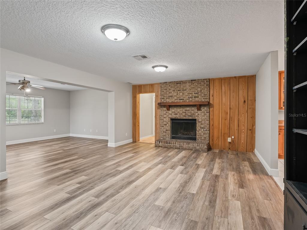 8234 Highway 301 Bushnell, FL 33513 - Photo 8 of 52 wooden floor fireplace and natural light in room