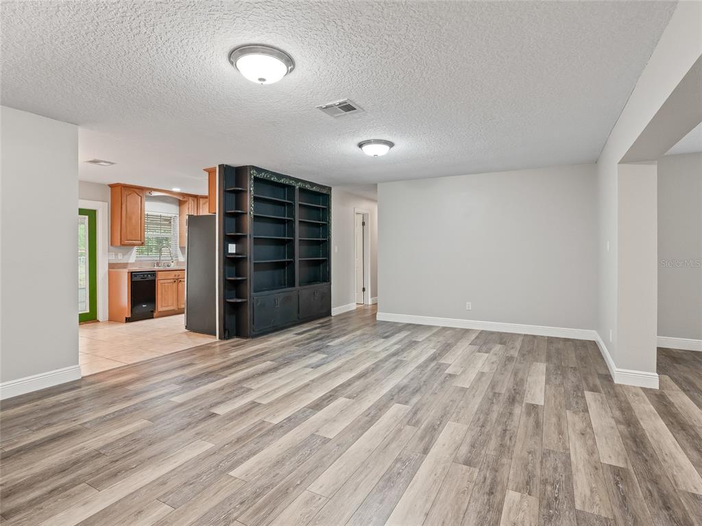 8234 Highway 301 Bushnell, FL 33513 - Photo 9 of 52 a view of an empty room with a closet and cabinet