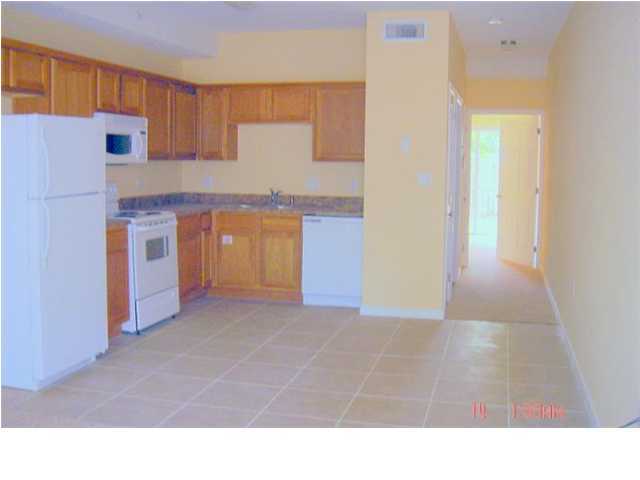 940 Barrow Street, Unit 1 Fort Walton Beach, FL 32547 - Photo 4 of 8 a kitchen with stainless steel appliances granite countertop a refrigerator a stove and a sink
