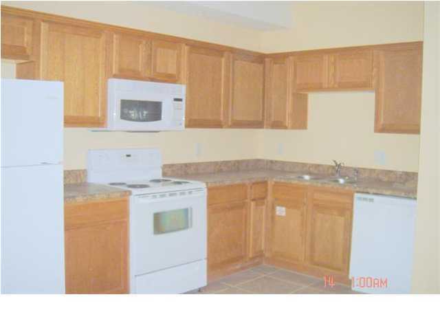 940 Barrow Street, Unit 1 Fort Walton Beach, FL 32547 - Photo 5 of 8 a kitchen with stainless steel appliances granite countertop a stove a sink and a microwave