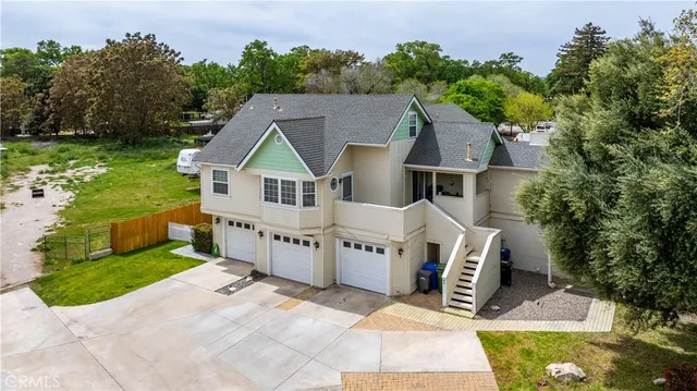a view of a house with a yard and potted plants